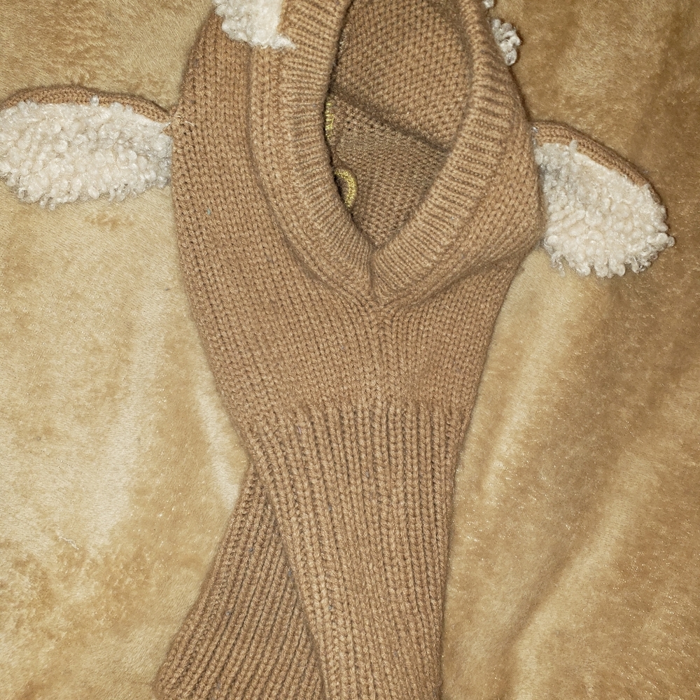 Small child next and head warmer meant to look like a lamb